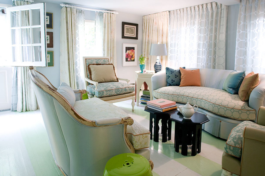 Subtle tonal patterned drapery adds dimension and plays off the prints in this living room designed b