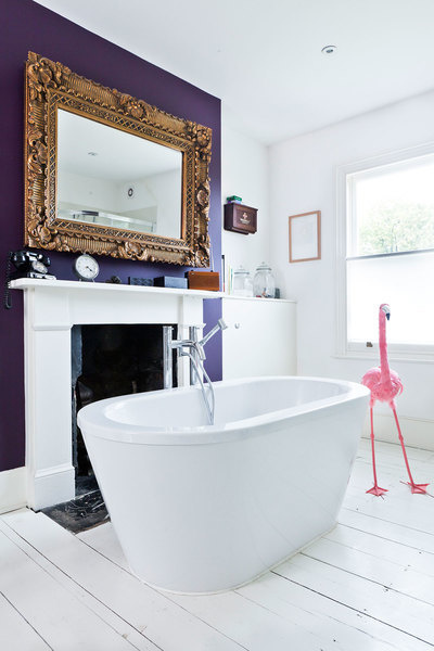 A bathroom is a perfect place to experiment with color as seen here with this ultra violet accent wal