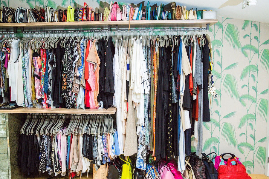Designed by Lisa Adams of LA Closet Design, this closet features lively green tropical-printed wallpa